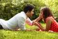 Couple in love lying on the grass in the park Royalty Free Stock Photo