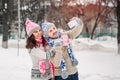 couple in love making selfie on winter outdoors in sweaters, scarf and mittens Royalty Free Stock Photo