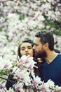 Couple in love, man kissing woman at blossoming trees, magnolia Royalty Free Stock Photo