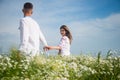 couple in love. man and woman in camomile field. summer flower meadow. Royalty Free Stock Photo