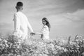 couple in love. man and woman in camomile field. summer flower meadow. Royalty Free Stock Photo