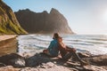 Couple in love man and woman enjoying Kvalvika beach view travel lifestyle