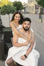 A couple in love, a man and a woman, hug and kiss on a wooden city bench at dawn. Royalty Free Stock Photo