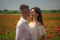 couple in love. man and woman in poppy field. summer flower meadow. Royalty Free Stock Photo