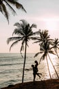 A couple in love meets a sunset on the sea among the palm trees. Man and woman at sunset. Honeymoon on the Islands. Honeymoon trip Royalty Free Stock Photo