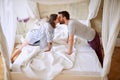 Couple in love kissing across canopy bed Royalty Free Stock Photo