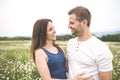 Couple in love outdoor at the sunset daisy