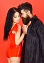 Couple in love, perfect match. Couple on pensive faces play role game. Man and woman dressed like vampire, demon, red Royalty Free Stock Photo