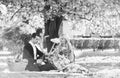 Couple in love picnic date. Enjoying their perfect date. Happy loving couple relaxing in park with food. Romantic picnic Royalty Free Stock Photo