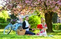 Couple in love picnic date. Spring weekend. Romantic picnic with wine. Flowers symbol of romance and affection. Enjoying Royalty Free Stock Photo