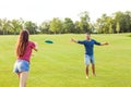 couple in love playing frisbee in the park, the concept of a healthy lifestyle. Royalty Free Stock Photo