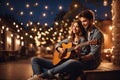 A couple in love playing guitar in the evening