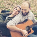 Couple in love playing serenade with guitar Royalty Free Stock Photo