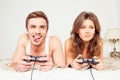 Couple in love playing video games in bedroom Royalty Free Stock Photo