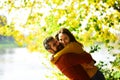 Couple in love plays and cuddles in park by river. Royalty Free Stock Photo