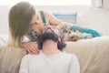 Couple in love with puppy laughing in their room Royalty Free Stock Photo