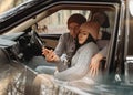 Couple in love resting in car in the forest Royalty Free Stock Photo