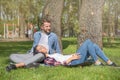 Couple in love are resting in the park and hugging. Handsome man and attractive girl on a date Royalty Free Stock Photo