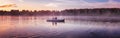 Couple in love ride in a rowing boat on the lake during sunset. Romantic sunset in golden hour. Happy woman and man together relax Royalty Free Stock Photo