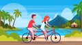 Couple in love riding tandem bicycle summer vacation sea beach landscape beautiful seaside man woman lovers cycling twin Royalty Free Stock Photo