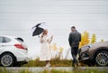 Couple in love on the road near cars under cloudy sky Royalty Free Stock Photo