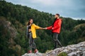 A couple in love on a rock admires the beautiful views. A man and a woman on a rock. A couple in love travels. Royalty Free Stock Photo