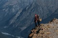 A couple in love on a rock admires the beautiful views. A man and a woman on a rock. A couple in love travels. Royalty Free Stock Photo