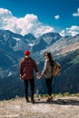 A couple in love on a rock admires the beautiful views. A man and a woman on a rock. A couple in love travels. Royalty Free Stock Photo