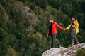 A couple in love on a rock admires the beautiful views. A man and a woman on a rock. A couple in love travels. Royalty Free Stock Photo