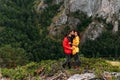 A couple in love on a rock admires the beautiful views. A man and a woman on a rock. A couple in love travels. Royalty Free Stock Photo