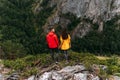 A couple in love on a rock admires the beautiful views, rear view. A man and a woman on a rock. A couple in love travels. Royalty Free Stock Photo