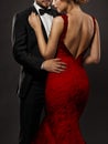 Couple in Love. Romantic Fashion Glamour Woman in red Dress and Elegant Man in Suit. Black Studio Background Royalty Free Stock Photo