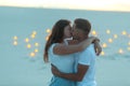 Couple in love romantic hugs in sand desert. Evening, romantic atmosphere, in sand burn candles