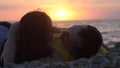 Couple in love romantically lay under the sun together look each other during beautiful sunset Royalty Free Stock Photo