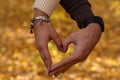 A couple in love shows a heart with their hands Royalty Free Stock Photo