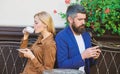 Couple in love sit cafe terrace enjoy coffee. Man secret messaging cheating on wife. Cheat and betrayal. Family weekend Royalty Free Stock Photo