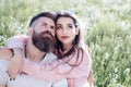 Couple in love sits on grass spring day. Sensual relationship and enjoying romantic moment. Spring leisure concept Royalty Free Stock Photo