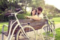 Couple in love sitted togheter on a bench with bikes beside Royalty Free Stock Photo