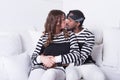 Couple in love sitting on couch kissing Royalty Free Stock Photo