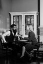 Couple in love sitting with martini glasses at table Royalty Free Stock Photo