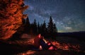 Pleasant rest of two hikers under open starry sky. Royalty Free Stock Photo
