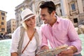 Couple in love sitting on Trevi Foutain of Rome