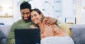 Couple, love and smile with laptop on sofa to watch movies, comedy subscription and online shopping at home. Happy man Royalty Free Stock Photo