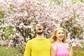 Couple in love in spring magnolia flowers, happy man, woman Royalty Free Stock Photo