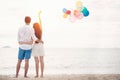 Couple in love stand on beach with bolloon