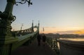 Couple in love is standing on the liberty bridge over the river Danube in Budapest. Sunrise in the big city. Dark silhouettes of Royalty Free Stock Photo