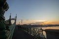 Couple in love is standing on the liberty bridge over the river Danube in Budapest. Sunrise in the big city. Dark silhouettes of Royalty Free Stock Photo