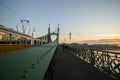 Couple in love is standing on the liberty bridge over the river Danube in Budapest. Sunrise in the big city. Dark silhouettes of Royalty Free Stock Photo