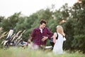 Couple in love standing at a motorbike. Green nature.