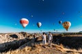 Couple in love stands on background of balloons in Cappadocia. The couple travels the world. Vacation in Turkey. Honeymoon trip. Royalty Free Stock Photo